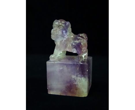 A Chinese amethyst desk seal of square form surmounted with a fo dog, probably 19th century, height 6.7cm.