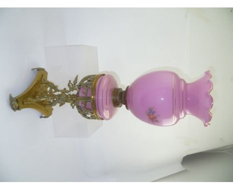 A LATE VICTORIAN OIL LAMP with decorative brass base, pink glass reservoir and shade, overall height 54cm 