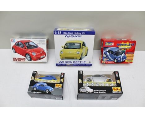 A TAMIYA VW NEW BEETLE MODEL KIT, a Revell easykit delux VW new beetles, a Gate 1:18 scale die-cast hobby kit and two Maisto 