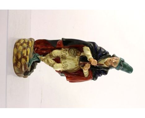 A ROYAL DOULTON EARTHENWARE FIGURINE "THE PIED PIPER", with long blue and red lined cloak and instrument in hand, ref. HN2102