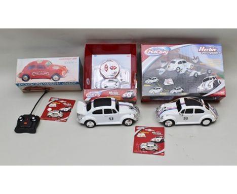 A BOXED LOW FRICTION MODEL VOLKSWAGEN VW BEETLE with sound effects in original vending box, together with two Herbie VW Beetl