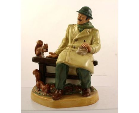 A ROYAL DOULTON EARTHENWARE MODEL "LUNCHTIME", a gentleman in long coat feeding squirrels, HN2485, 20cm high 