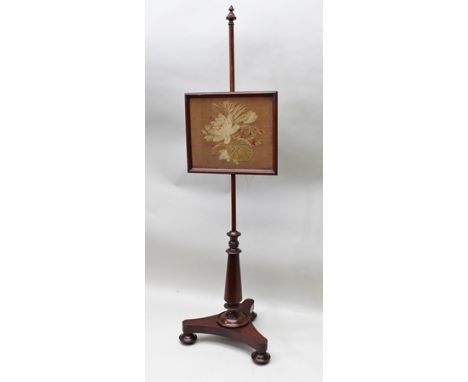 A VICTORIAN MAHOGANY POLE SCREEN the adjustable panel with woven floral decoration inset, raised on turned stem, triform plat