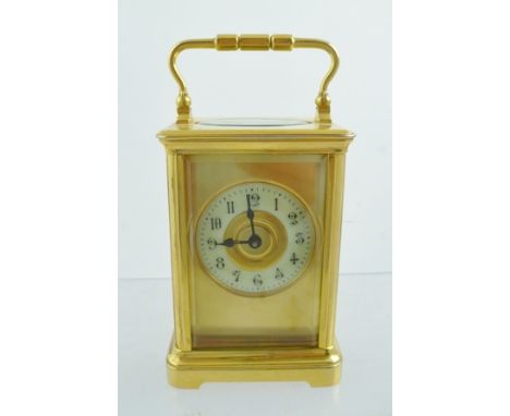 A 20TH CENTURY GILT BRASS FRENCH CARRIAGE TIMEPIECE eight day with lever platform escapement, faced by a gilt mask with Arabi