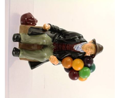 A ROYAL DOULTON EARTHENWARE MODEL "THE BALLOON MAN", seated in a long coat, HN1954, 19cm high 