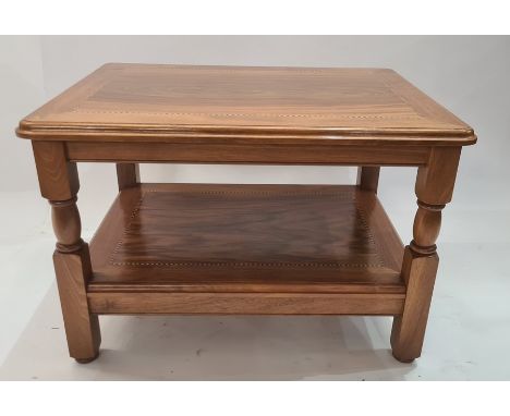 20th century walnut two tier coffee table, the rectangular top with rounded corners, moulded edge on turned and block support