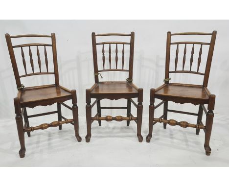 Set of eight country oak and elm railback dining chairs each with quadruple baluster spindles to the back, panel seat with se