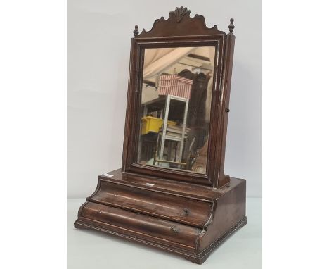 19th century mahogany swing toilet mirror, the rectangular plate surmounted by carved and shaped top, on fluted supports, the