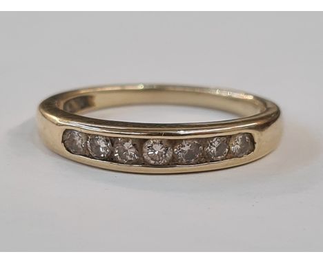 Gold and diamond half eternity ring, the seven diamonds channel set 
