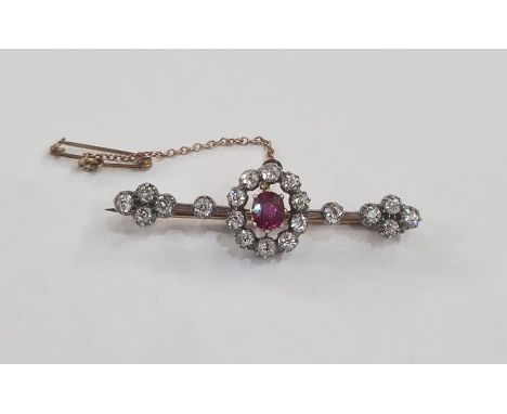 Antique ruby and diamond bar brooch set oval ruby surrounded by circlet of diamonds and further diamonds to the bar in gilt l