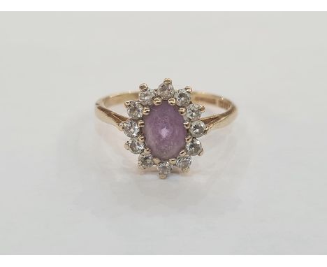 9ct gold, amethyst-coloured stone and white stone dress ring, the oval purple stone surrounded by small white stonesCondition