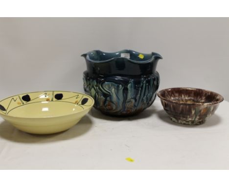 A HAND PAINTED POOLE POTTERY BOWL, TOGETHER WITH A MAJOLICA STYLE JARDINAIRE AND A GERMAN POTTERY BOWL (3) 
