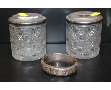 TWO HALLMARKED SILVER TOPPED CUT GLASS VANITY JARS, TOGETHER WITH A HALLMARKED SILVER ENGRAVED BANGLE APPROX SILVER WEIGHT- 6