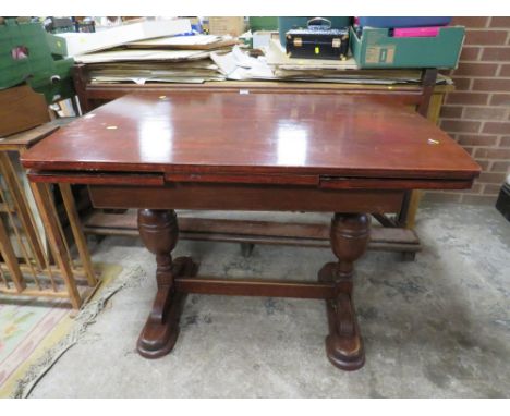 A VINTAGE DRAWLEAF DINING TABLE