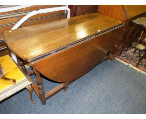 A HEAVY OAK 19TH CENTURY GATE LEG DINING TABLE