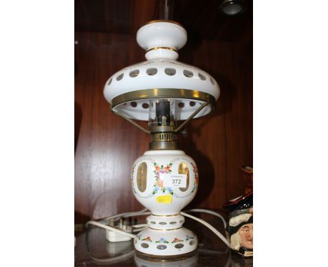A VINTAGE CONVERTED GLASS OIL LAMP WITH WHITE GLASS OVERLAY WITH SHADE AND FLUE H- 47CM 