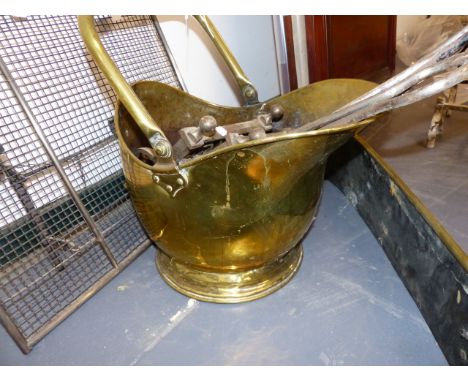 A GROUP OF VARIOUS FIRESIDE TOOLS TOGETHER WITH A SPARK GUARD, A COAL SCUTTLE AND A BRASS FENDER.