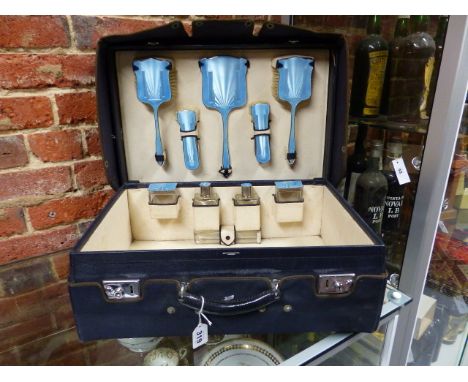 A  SILVER HALLMARKED VANITY TRAVEL SET IN POWDER BLUE WITH AN ART DECO GUILLOCHE ENAMEL DESIGN IN A LEATHER DRESSING CASE, DA