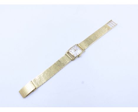 AN 18ct STAMPED LADIES VINTAGE MANUAL WOUND LONGINES WATCH. THE BRICK STYLE BRACELET WITH LADDER CLASP IS STAMPED 750, WITH T