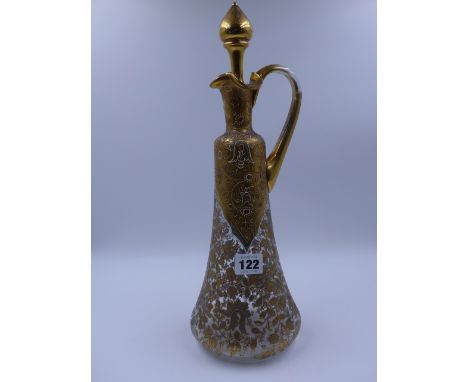 A LATE 19th.C. FRENCH GLASS DECANTER AND STOPPER EMBELLISHED WITH GILDING.   39cms. HIGH.