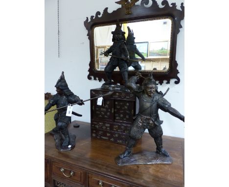 THREE BRONZE FIGURES OF SAMURAI WARRIORS, EACH HOLDING A DIFFERENT WEAPON.   H.57cms.