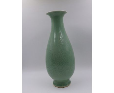 A CHINESE CELADON TAPERED BALUSTER FORM VASE WITH INCISED FLORAL DECORATION AND SEAL MARK TO BASE.   H.35cms.