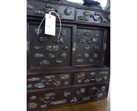 AN ANTIQUE JAPANESE TABLE CABINET VARIOUSLY DECORATED WITH BRONZE MINUKI TYPE MOUNTS