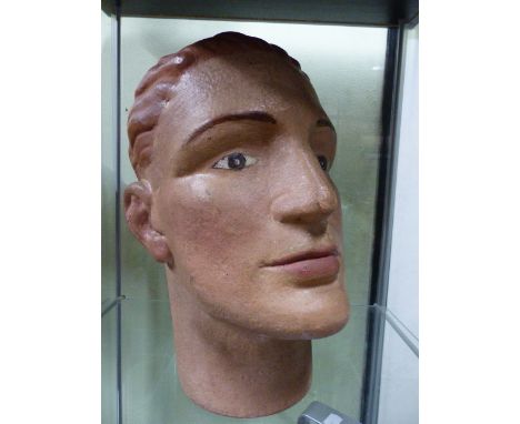 AN EARLY 20th.C.PLASTER MANNEQUIN HEAD WITH WELL PAINTED FEATURES.