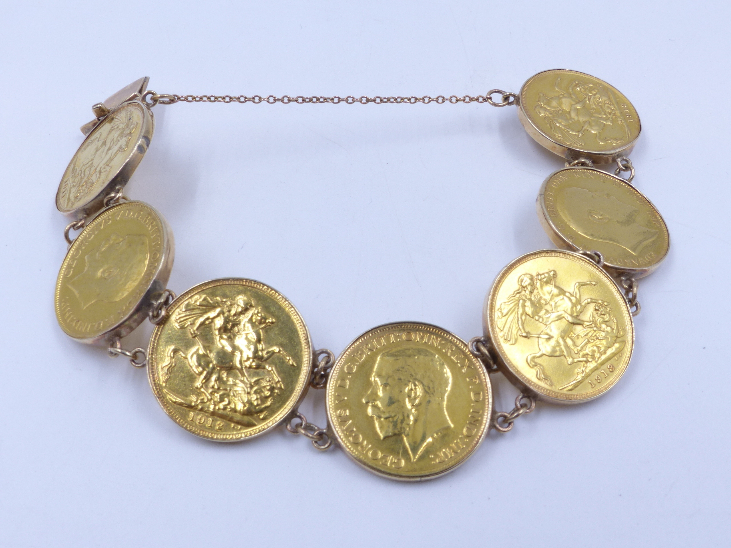 A GOLD SOVEREIGN BRACELET MADE UP OF SEVEN INDIVIDUALLY SET FULL ...