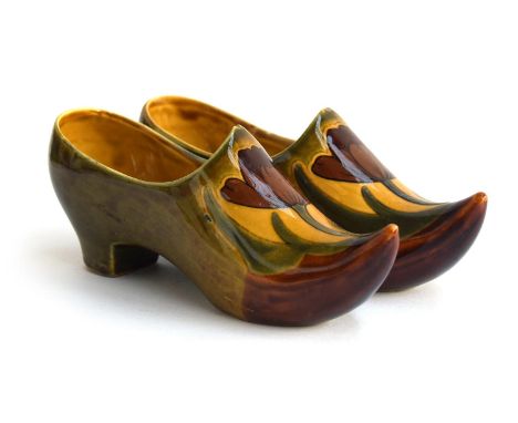 A pair of glazed continental ceramic clog ornaments, each painted with a tulip design, marked to base '3450', 7cm high 