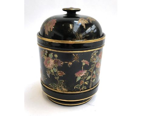 A glazed ceramic tobacco jar, black with chrysanthemum, bird and bee pattern, heightened in gilt, 19cmH 