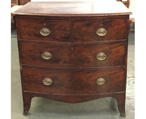 A early 19th century mahogany bow front chest of two short over two long drawers, on outswept bracket feet with shaped apron,