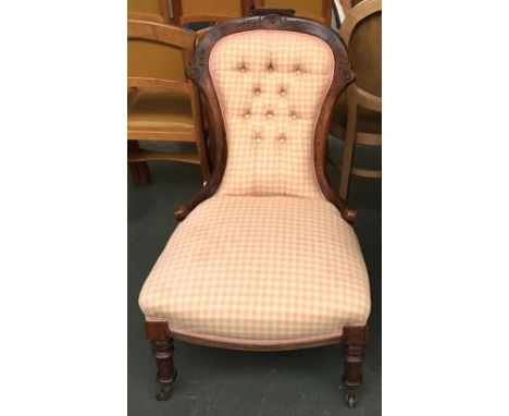 A button back bedroom chair on turned legs and casters 