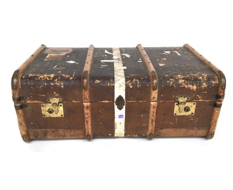 A travel trunk with removable tray and wood and brass bracings, side handles and vintage travel stickers, 88cmW 