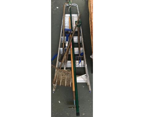 A quantity of garden tools including a hoe, shovel, forks, rake, and aluminium step ladder 