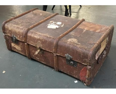 A large vintage travel trunk with wooden banding 