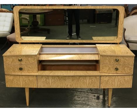 A 1950s formica dressing table, the central section lifting to reveal shelf, with built in light, flanked by four drawers, wi