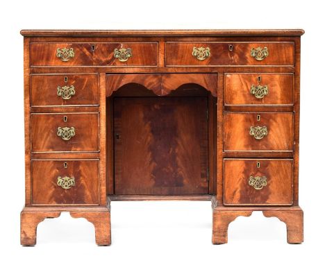 A late 19th century lady's kneehole dressing table/desk, the crossbanded top over two drawers, the kneehole flanked by six fu