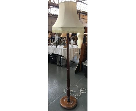 A turned wood standard lamp and shade 