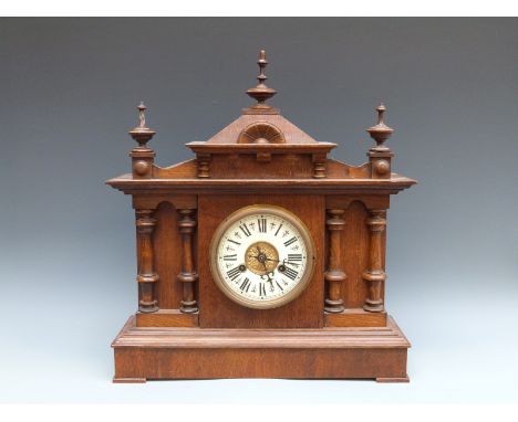 A Continental late Victorian / Edwardian oak cased two train mantel clock, the Roman ivory coloured chapter ring with beetle 