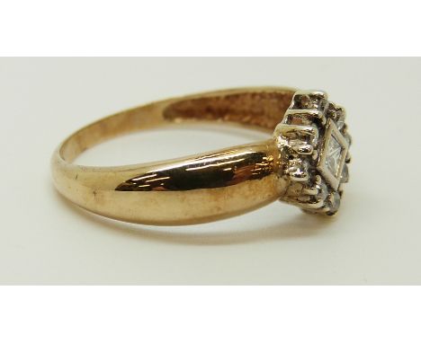 A 9ct gold ring set with a square cut diamond surrounded by round cut diamonds, 2.32g (size Q) 