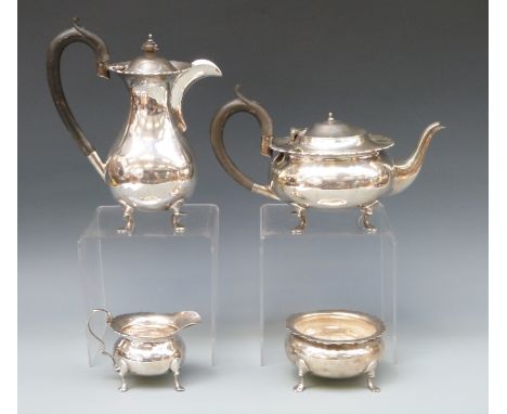 A George V hallmarked silver four piece tea service comprising teapot, hot water jug, milk jug and sugar bowl with shaped edg