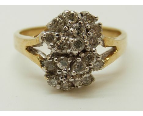 A 14ct gold ring set with diamonds in a cluster, 3.92g (size M) 