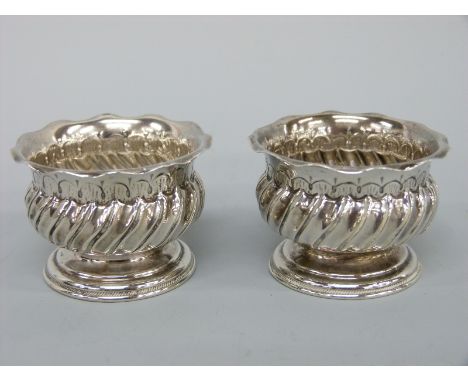 A pair of Victorian hallmarked silver pedestal salts with wrythen decoration and crimped rims, Birmingham 1890 maker Barnet H
