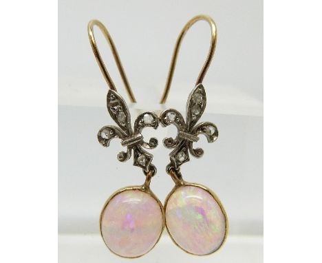 A pair of Victorian earrings set with an opal cabochon and diamonds in the form of a fleur de lys, in original box 