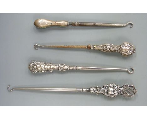 Four various hallmarked silver handled button hooks
