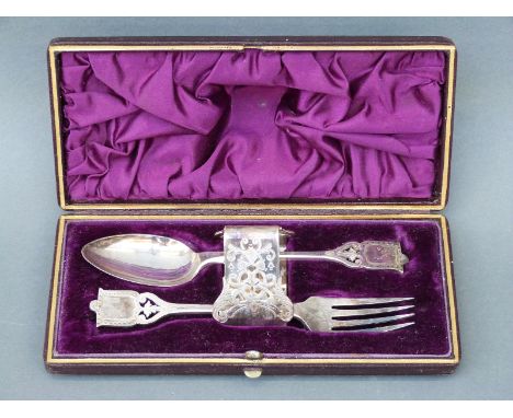 A cased silver plated christening set comprising spoon, fork and napkin ring