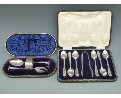 A cased set of six hallmarked silver teaspoons and tongs and a further cased christening set comprising napkin ring, spoon an