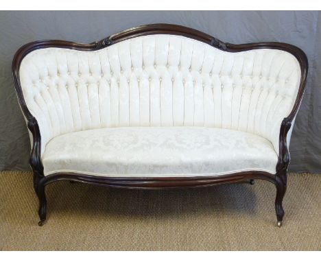 A Victorian upholstered sofa with show wood frame