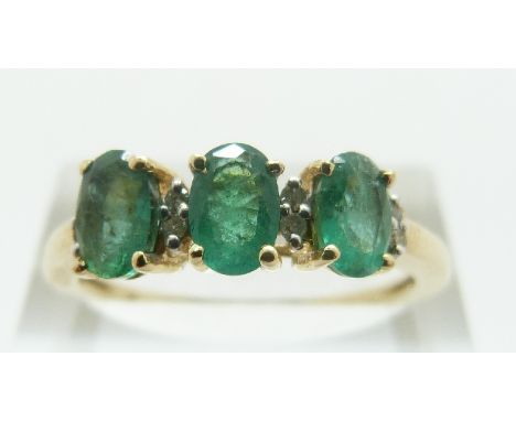 A 9ct gold ring set with three oval emeralds and diamonds, size R/S, 2.35g 